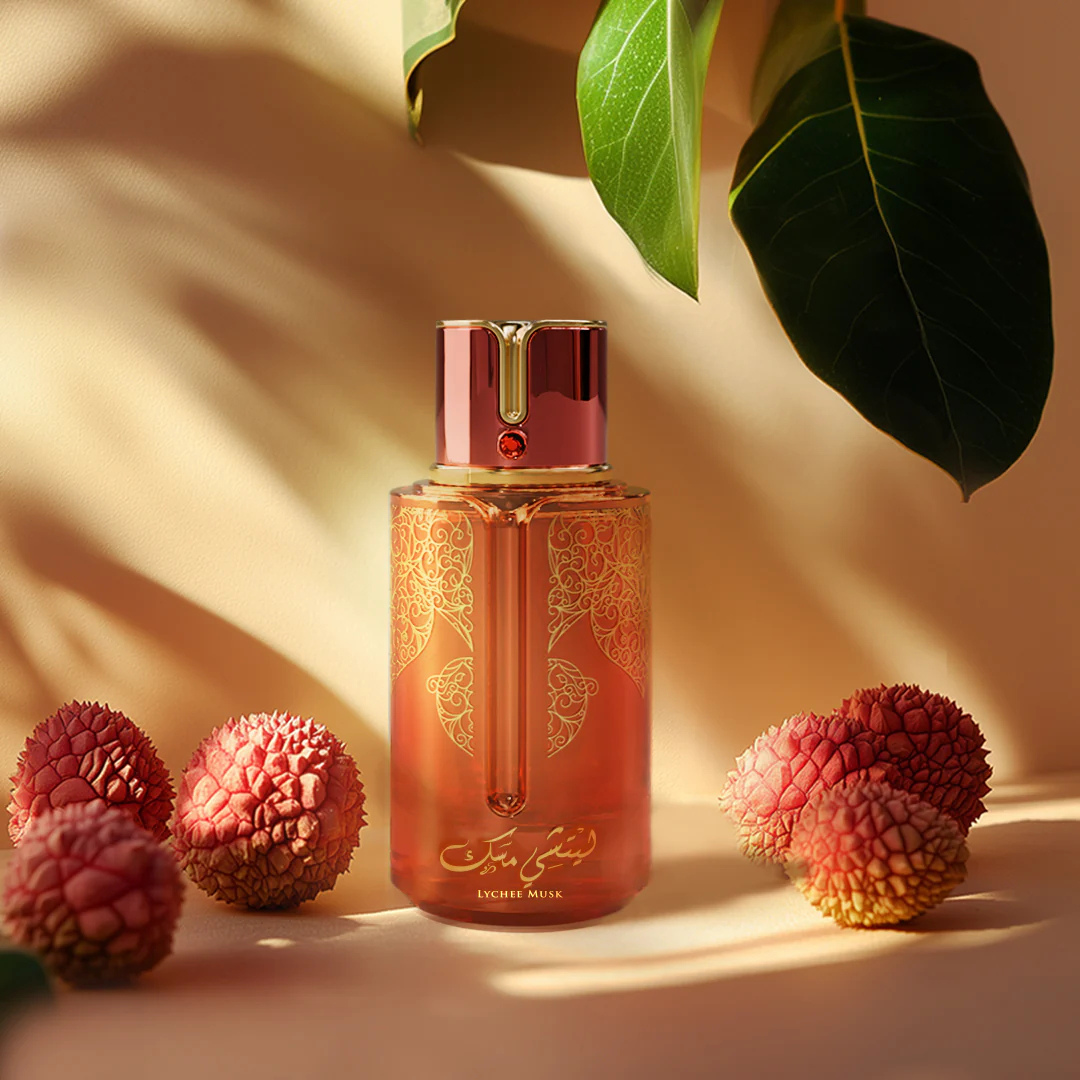 Lychee Musk Perfume by Arabiyat Prestige Eau de Parfum bottle with fresh lychee fruits and tropical leaves – feminine fruity musk fragrance photography.