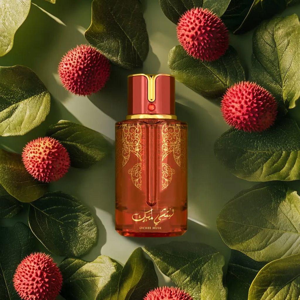 Lychee Musk perfume bottle by Arabiyat Prestige surrounded by ripe lychee fruits and green leaves – vibrant and exotic fruity fragrance visual.