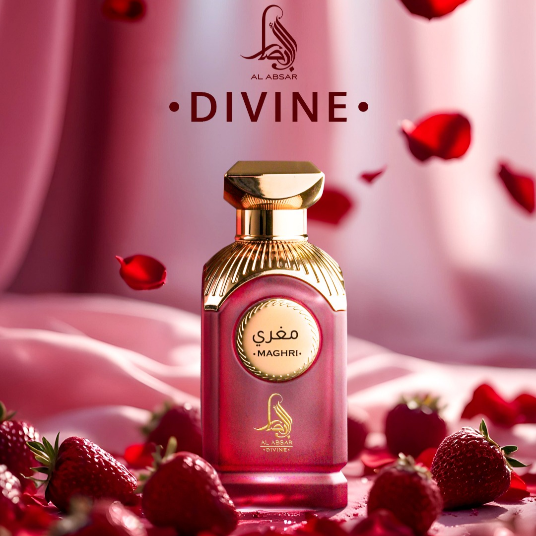 Perfume bottle with gold cap and pink body, surrounded by strawberries and red petals, on a soft pink background.