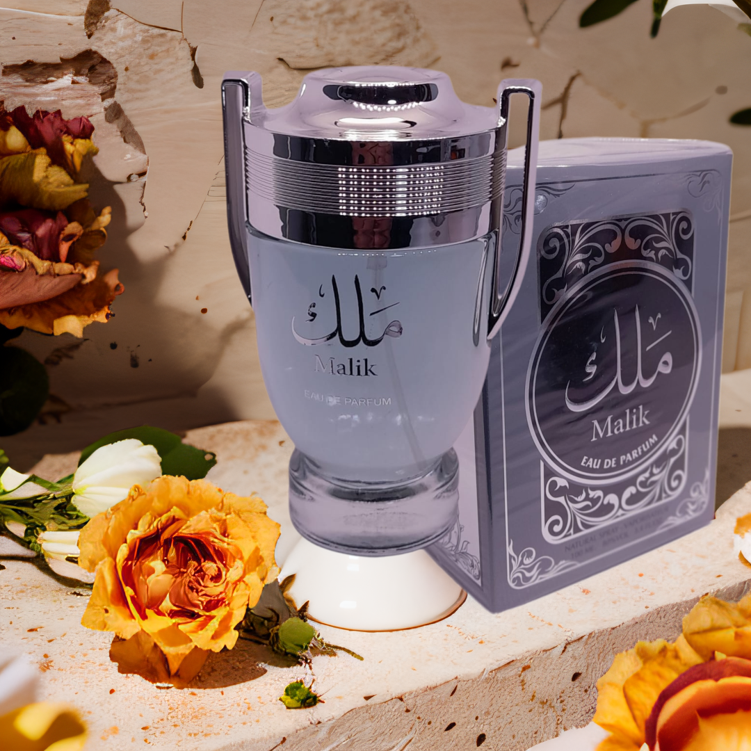 Malik perfume bottle and packaging with flowers on a textured surface. Malik Mens Perfume by Ard Al Zaafaran