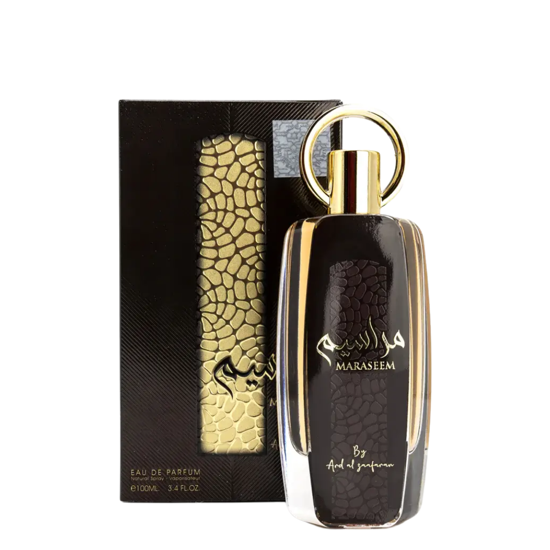 Perfume bottle with gold accents and 'Maraseem' branding next to its packaging on a white background