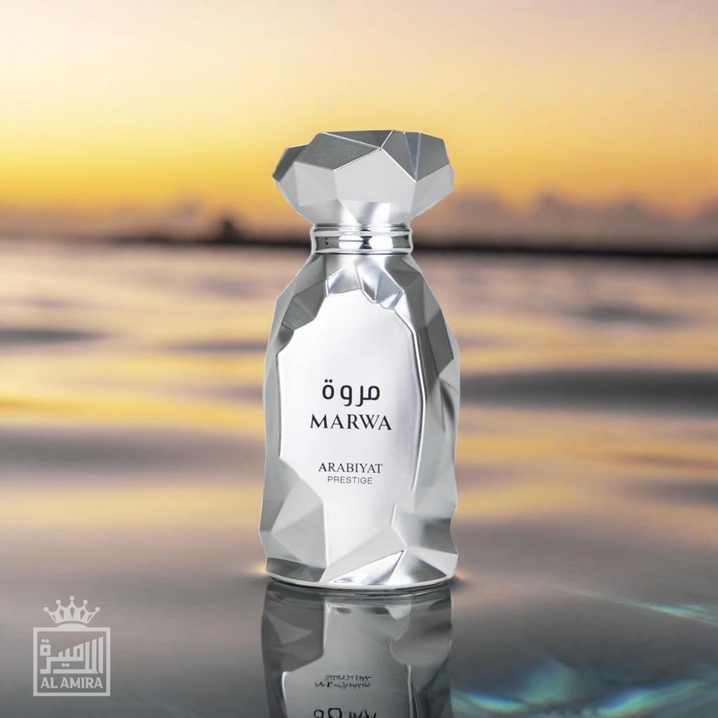 Marwa luxury fragrance perfume bottle by Arabiyat Prestige. Polished, shiny silver bottle with angular features. Beach and water  background. My Perfumes.