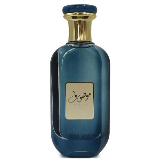 Mousuf Azure Eau de Parfum in elegant blue glass bottle with gold and blue cap, luxury Arabian fragrance for men and women. A blue perfume bottle with a gold cap, labeled with 'Mousuf Azure' by Ard Al Zaafaran. Clone / dupe of / inspired by Tom Ford - Azure Lime perfume.