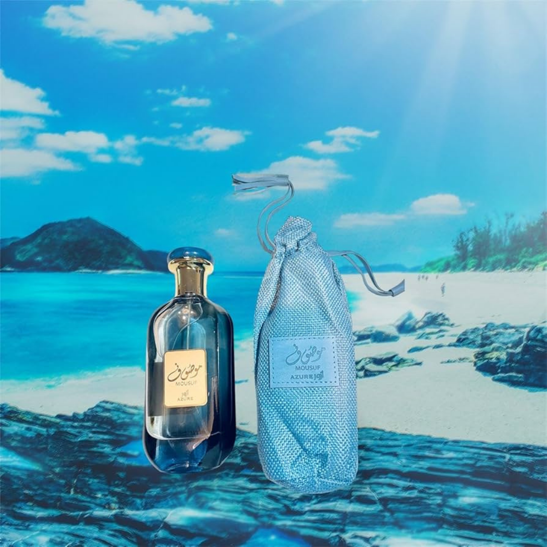 Mousuf Azure perfume and pouch displayed against tropical beach background, fresh aquatic Arabian scent. 