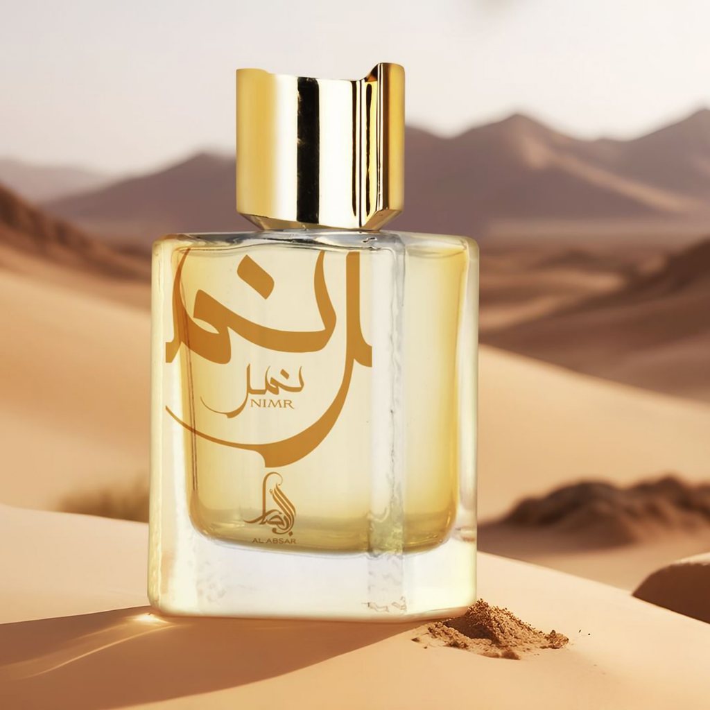 Perfume bottle with gold cap on sand dunes. Nimr by Al Absar Unisex Perfume