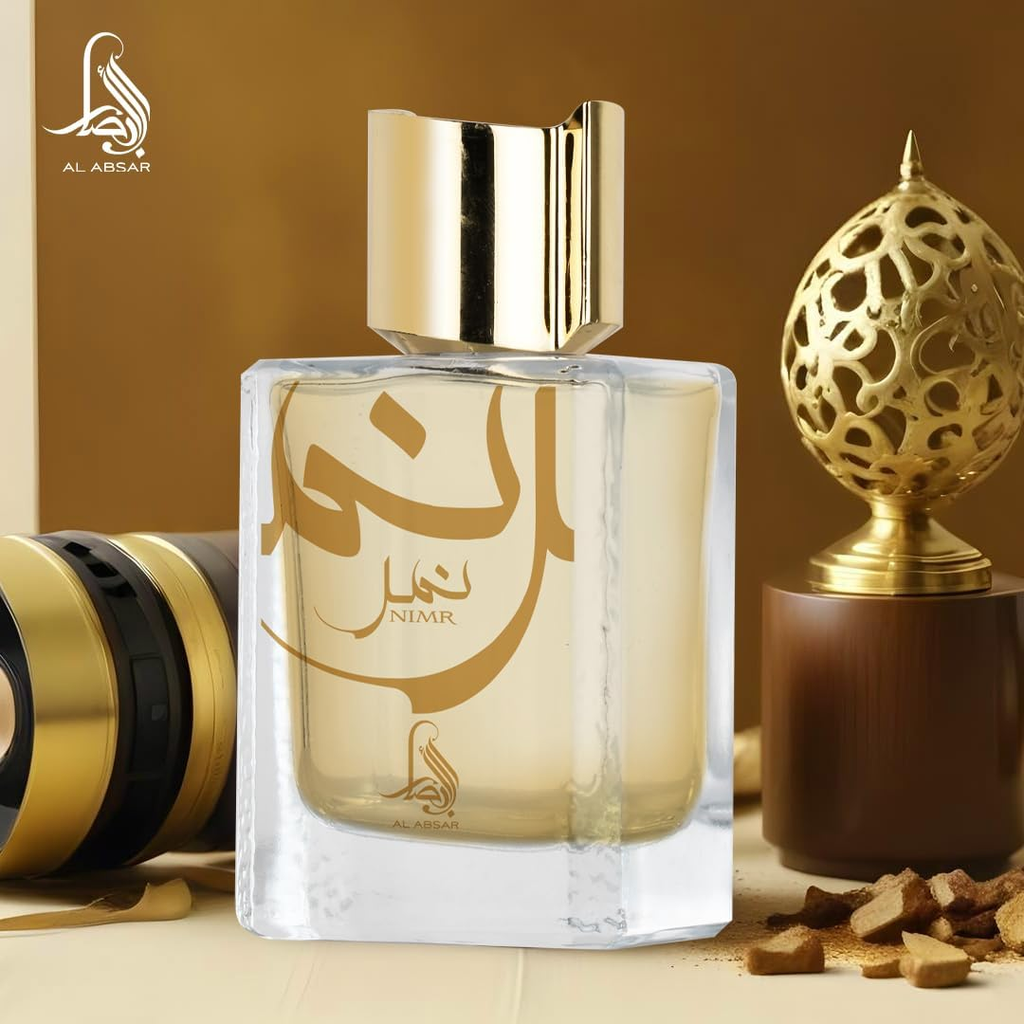 Perfume bottle with gold cap and 'Nimr' branding on a decorative background