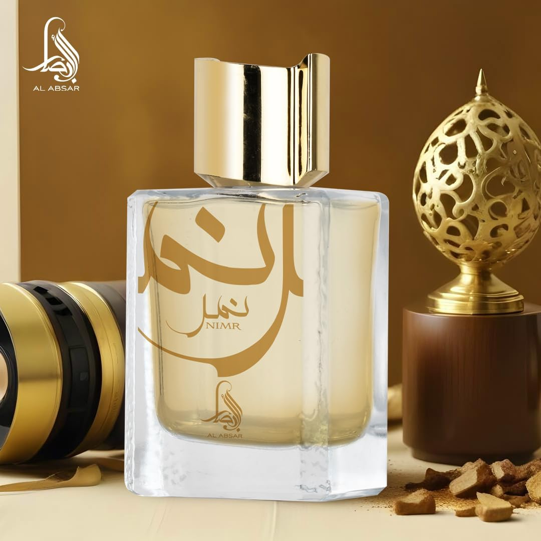 Perfume bottle with gold cap and 'Nimr' branding on a decorative background
