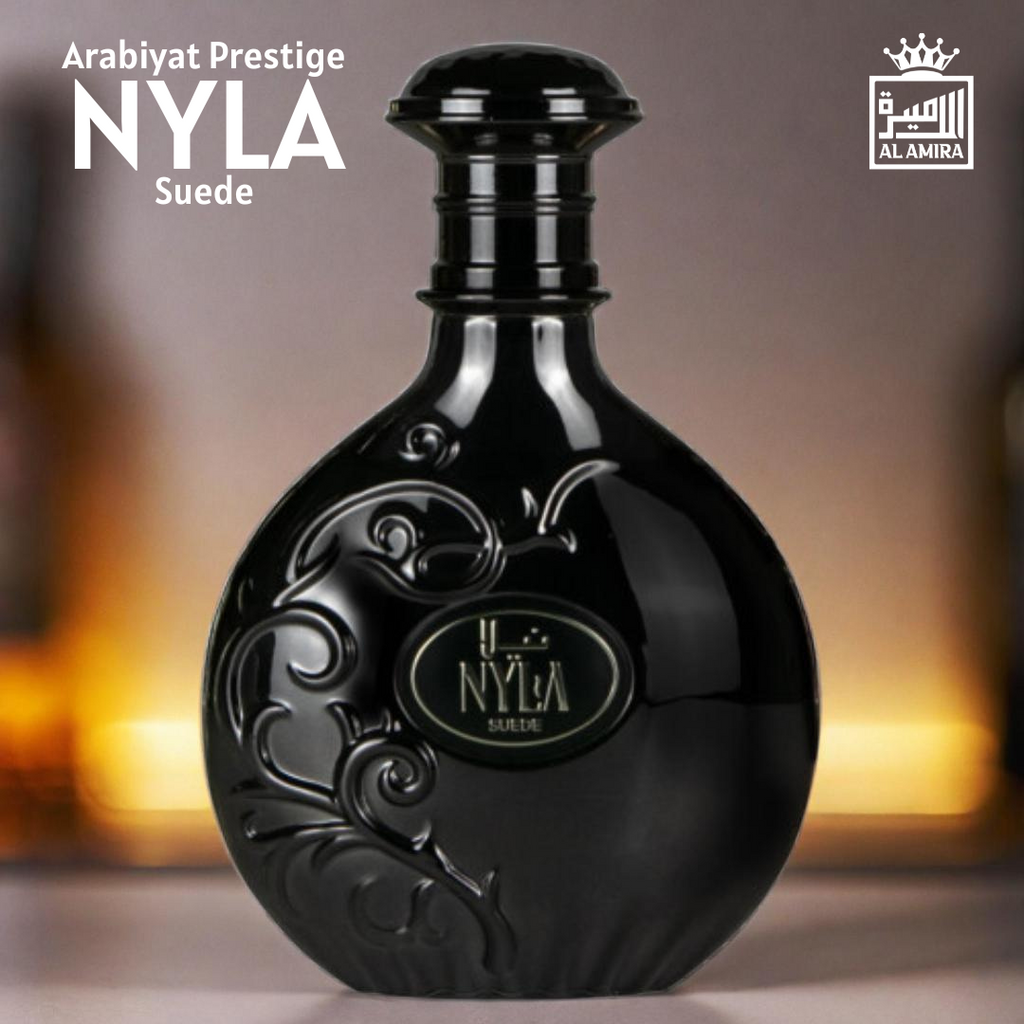 Arabiyat Prestige Nyla Suede luxury oriental fragrance bottle with gold logo, captured in warm ambient lighting for an elegant presentation.