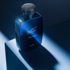 A dark blue glass perfume bottle with a silver cap, labeled 'HAWAS For Men GOLD DIGGER', displayed on a geometric pedestal with dramatic blue lighting.