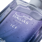 A close-up of a translucent blue-purple perfume bottle labeled 'HAWAS For Him ICE' with water droplets on the surface, set against a bright white background.