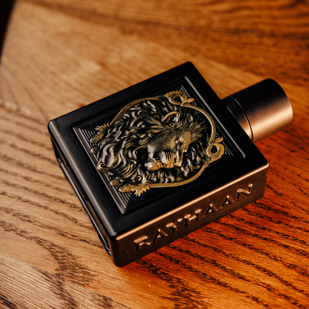 Decorative black and gold Perfume bottle with intricate design on a wooden surface. Rayhaan Lion Mens Perfume