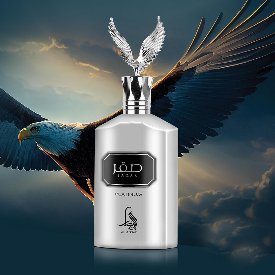 Silver perfume bottle with eagle wings against a cloudy sky