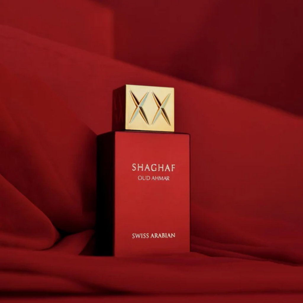 Red Shaghaf Swiss Arabian perfume bottle on a red background. Shaghaf Oud Ahmar Unisex Perfume