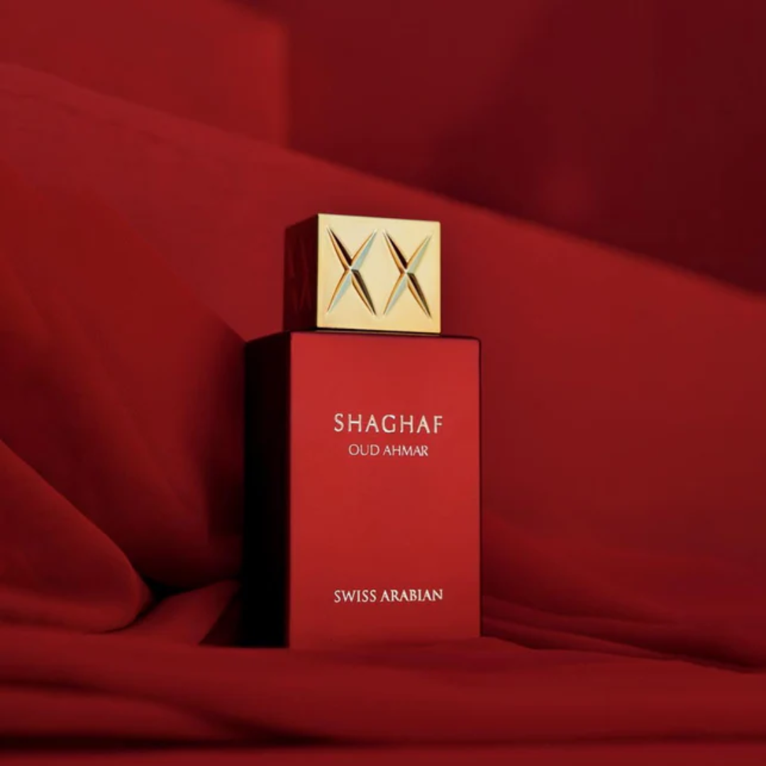 Red Shaghaf Swiss Arabian perfume bottle on a red background. Shaghaf Oud Ahmar Unisex Perfume
