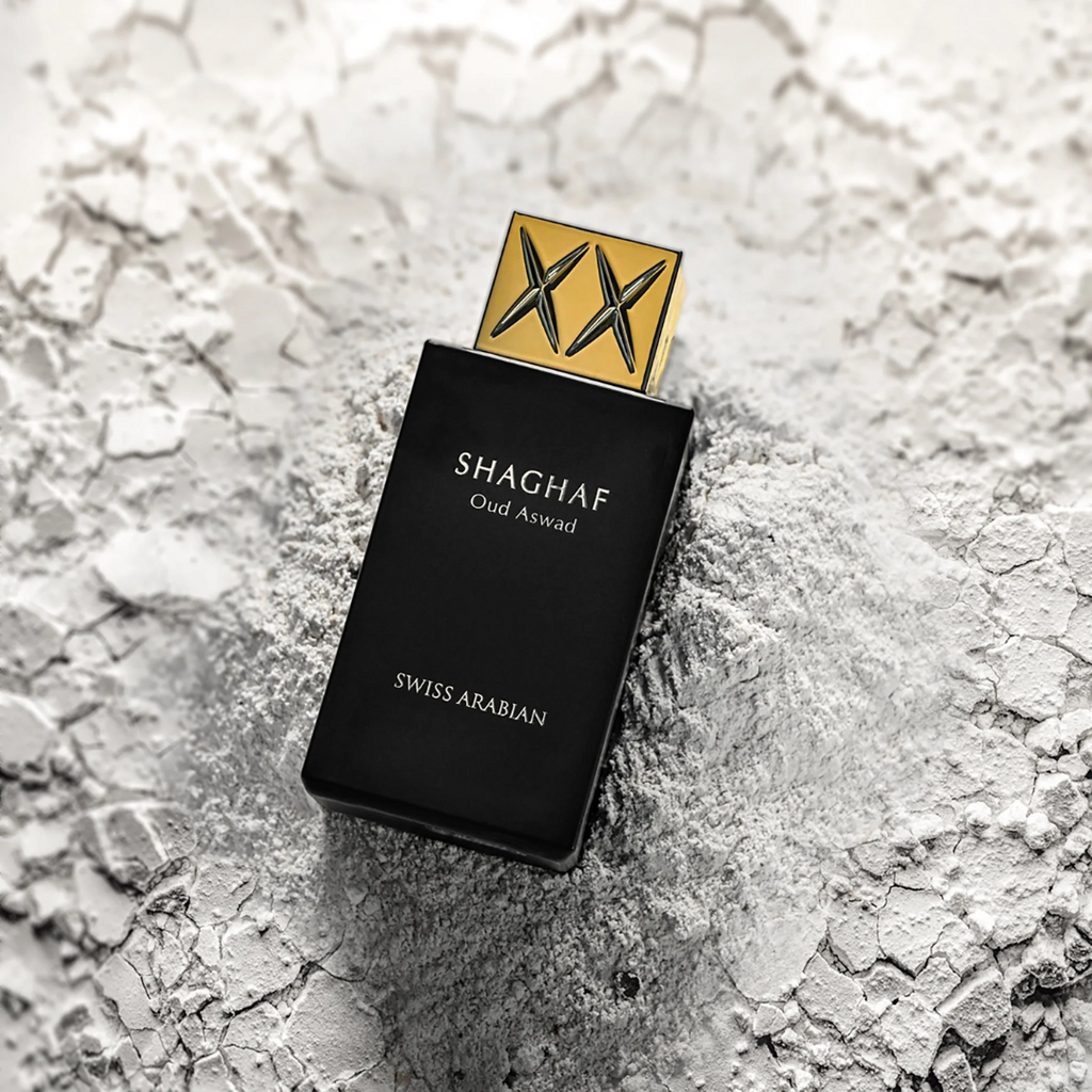Swiss Arabian Shaghaf Oud Aswad perfume bottle on a textured surface