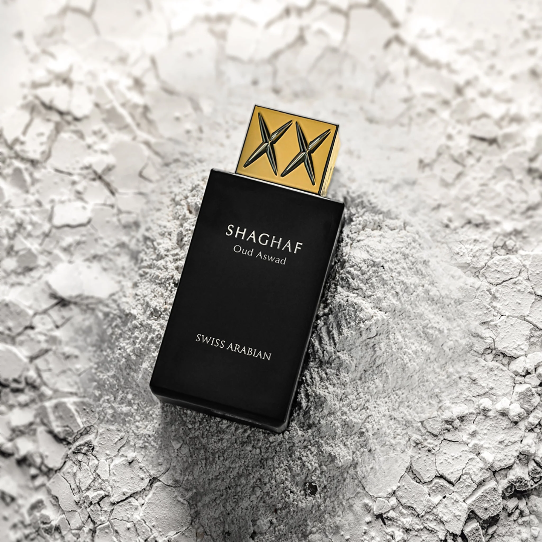 Swiss Arabian Shaghaf Oud Aswad perfume bottle on a textured surface