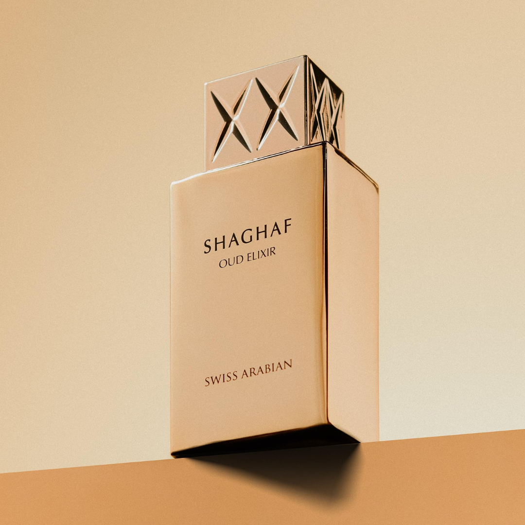 Shaghaf Oud Elixir perfume bottle by Swiss Arabian on a beige background