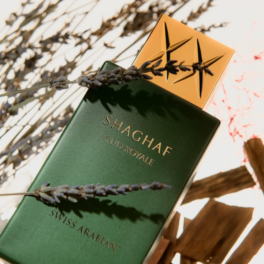 Shaghaf Clud Royale perfume bottle with lavender on a textured background
