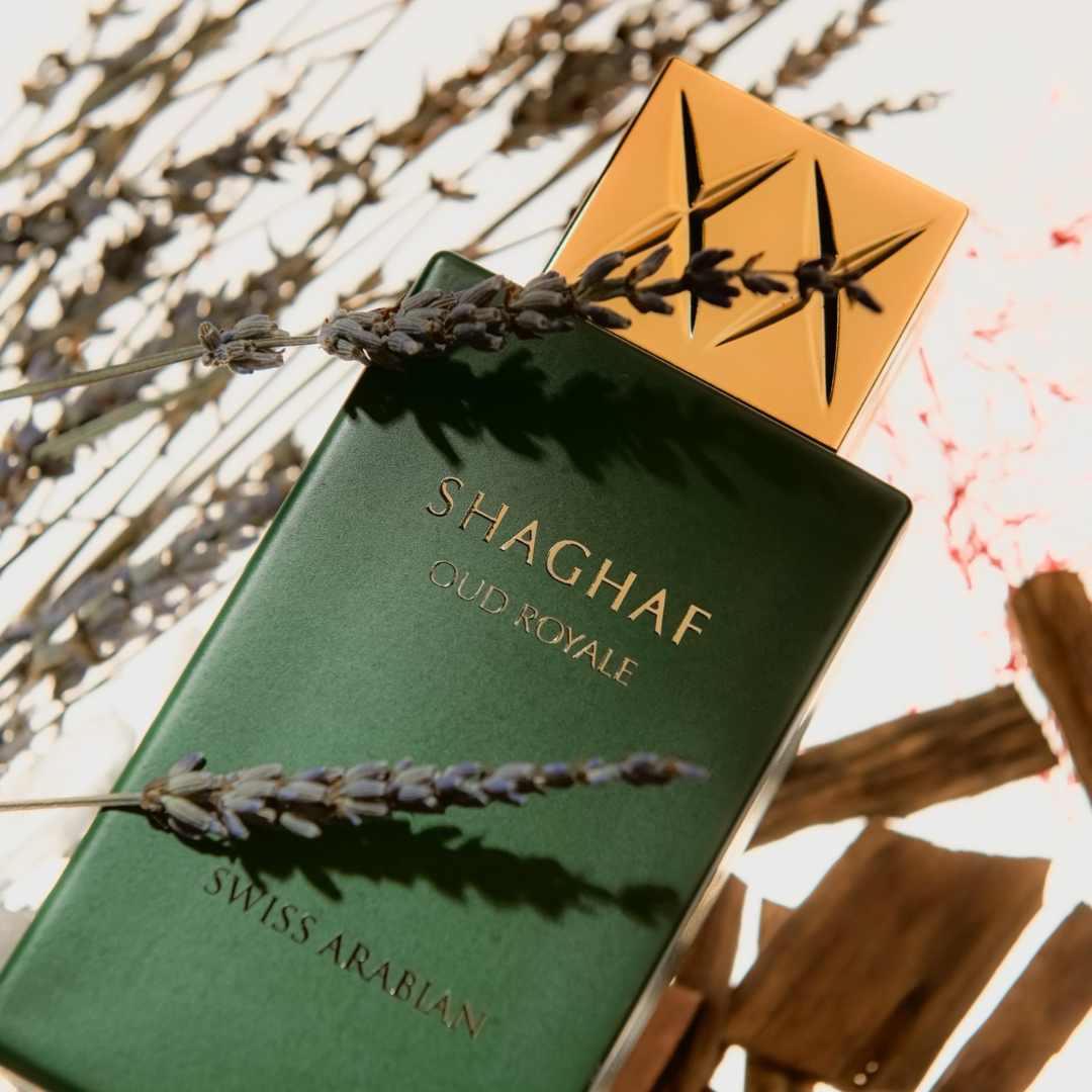 Shaghaf Clud Royale perfume bottle with lavender on a textured background
