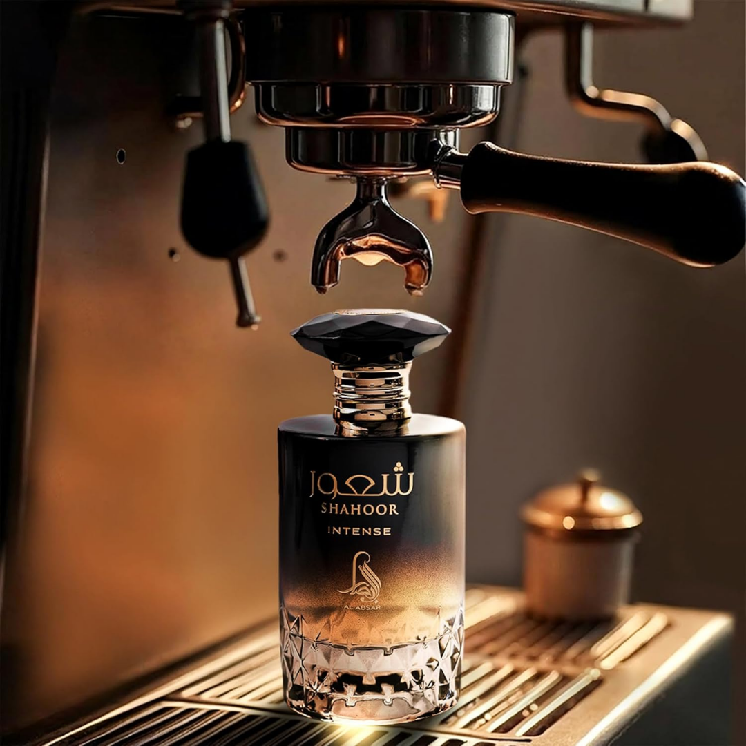 Perfume bottle labeled 'Shahoor Intense' under an espresso machine.