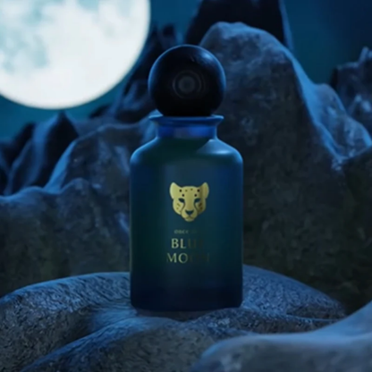 Blue bottle with a gold panther logo on a rocky surface with moonlight
