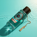 Surrati Imperial perfume bottle angled above green water.