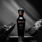 Surrati Italian Tobacco perfume bottle on charcoal-coloured stones.