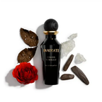 Surrati Italian Tobacco perfume bottle with decorative rose and wood props.