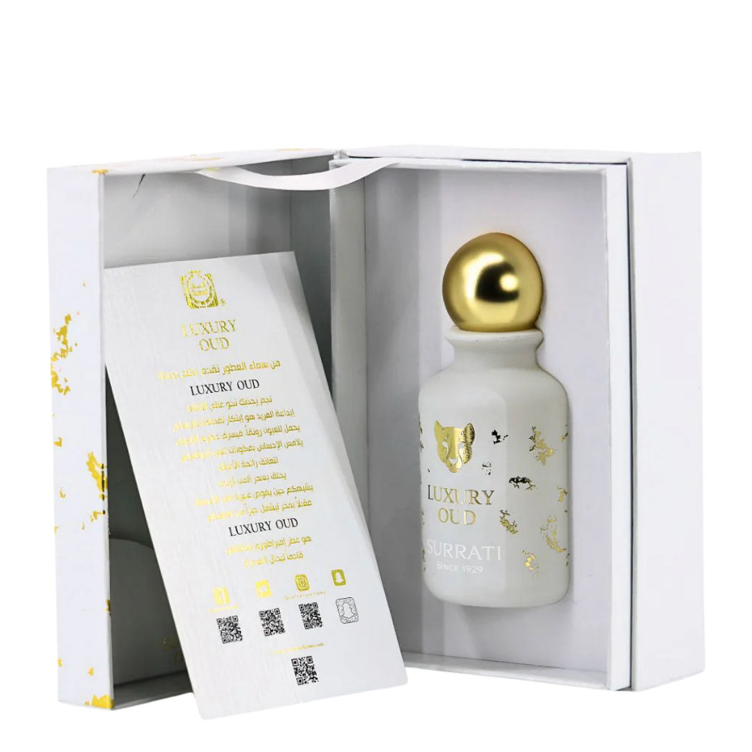 Perfume bottle with gold cap and packaging in a white box