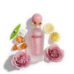 Surrati Miss World perfume bottle with decorative flowers, citrus and amber-coloured props.