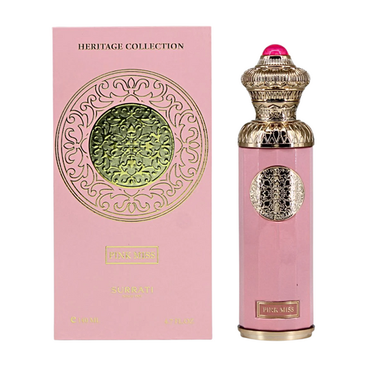 Pink perfume bottle with gold cap and intricate design next to its packaging on a white background. Surrati Pink Miss Womens Perfume
