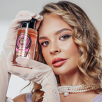 Model holding the Surrati Rose Vanilla perfume bottle.