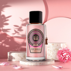 Surrati Rose Vanilla perfume bottle on pink fabric.