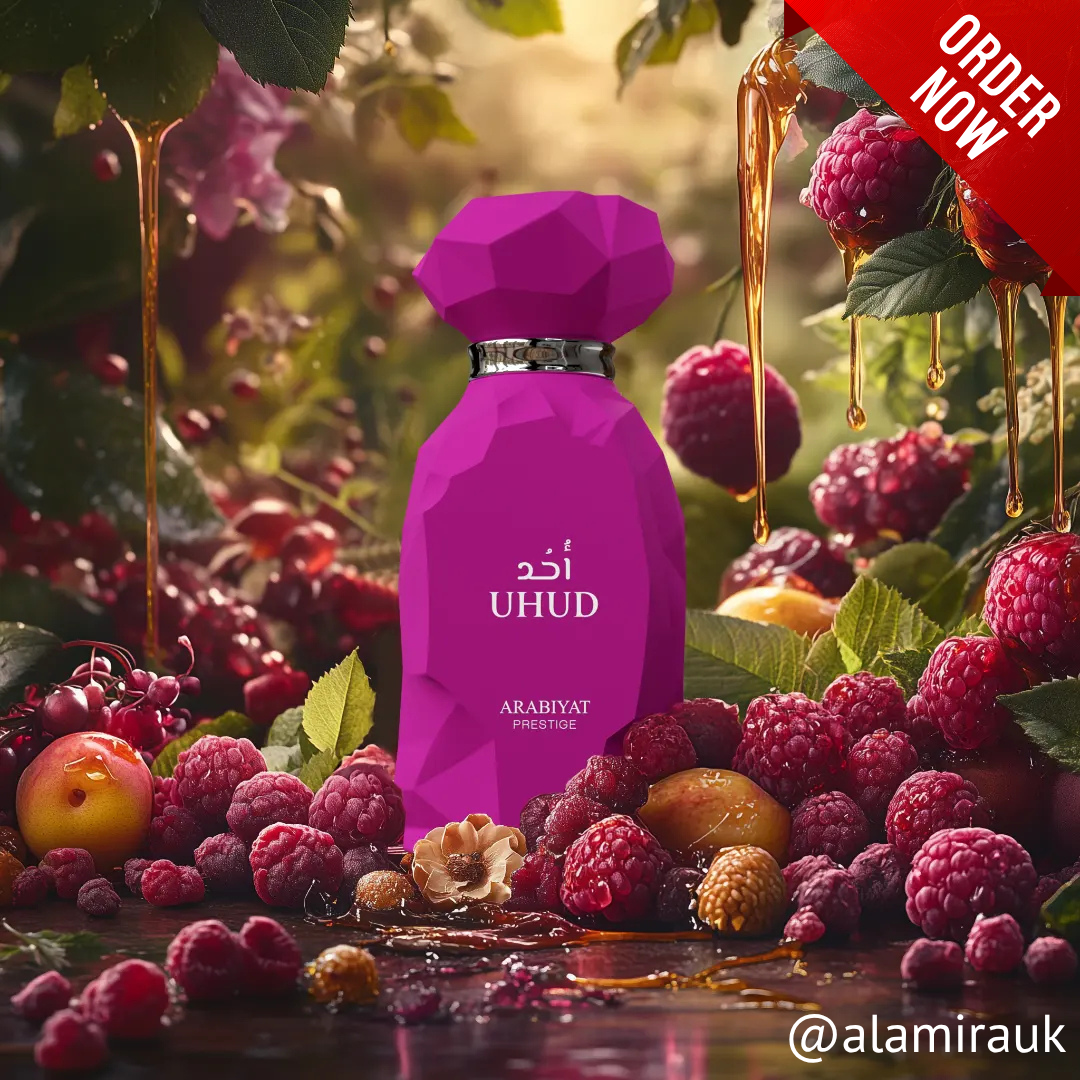 Purple perfume bottle with 'UHUD' branding surrounded by berries and fruits on a natural background. Uhud by Arabiyat Prestige Womens Perfume