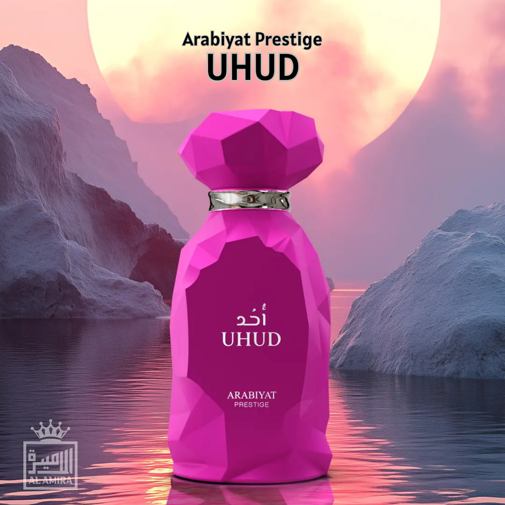 Pink perfume bottle labeled 'UHUD' by Arabiyat Prestige with a mountainous landscape in the background.