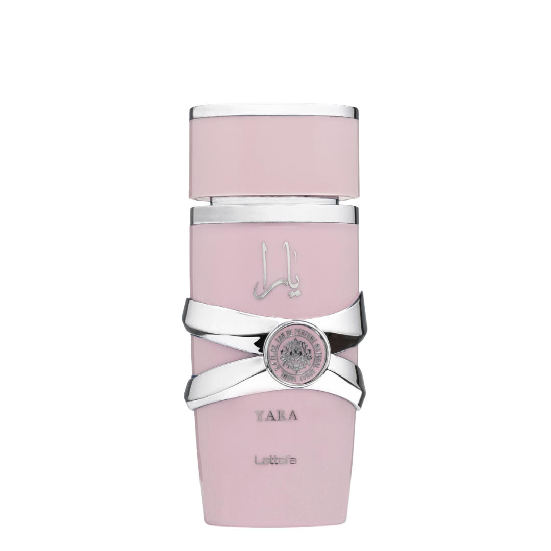 A bottle of Yara Eau de Parfum by Lattafa, featuring a pink hue with a silver-colored cap and label design.  Lattafa Yara perfume bottle in soft pink with silver accents and lion emblem, exuding elegance and femininity.